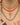 A paste riviere necklace, a coral necklace and a coral pendant worn on the neck