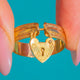 Textured 9ct Gold ring with hanging heart-padlock motif